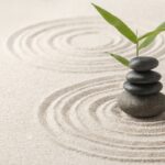 Stacked zen stones sand background art of balance concept