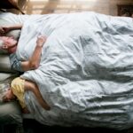 Elderly Caucasian couple sleeping